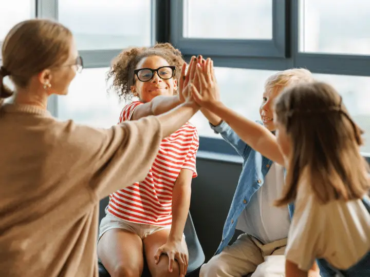 Therapist working with a group of kids and doing play therapy.