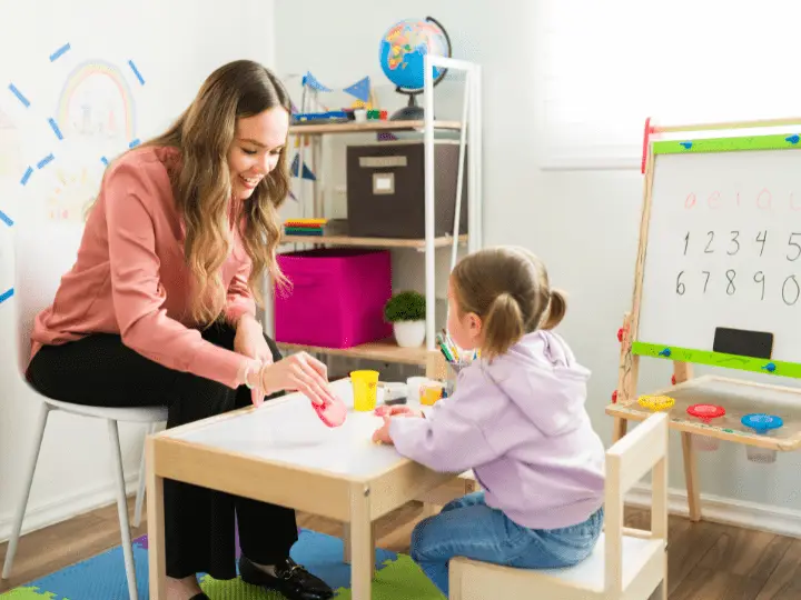 A therapist using play therapy techniques with a child to encourage emotional expression.