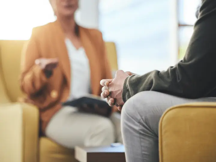 A therapist and client discussing therapy payment options during a counseling session at Willow Therapy Utah