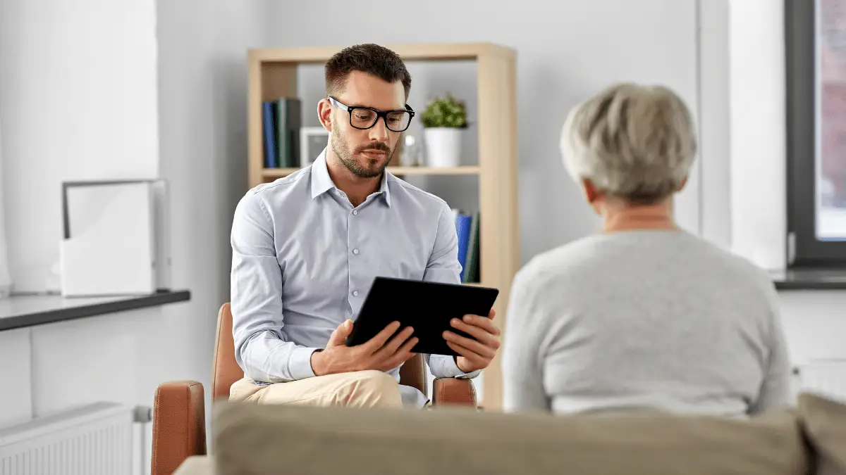 Older woman smiling during an online geriatric therapy session in Utah, feeling supported.